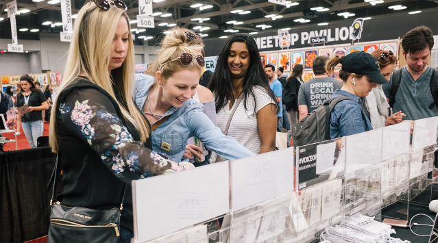 Marketplace attendees browse a local Austin boutique booth