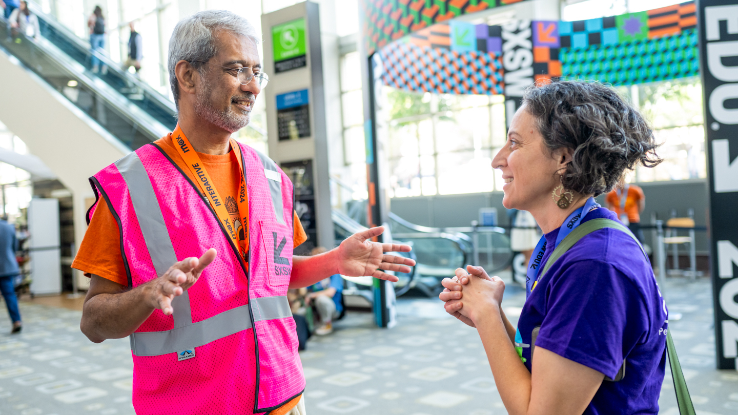 SXSW 2024 Volunteer assisting an attendee – Photo by Tico Mendoza